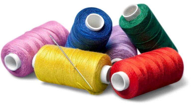 agulha com linhas de costura coloridas